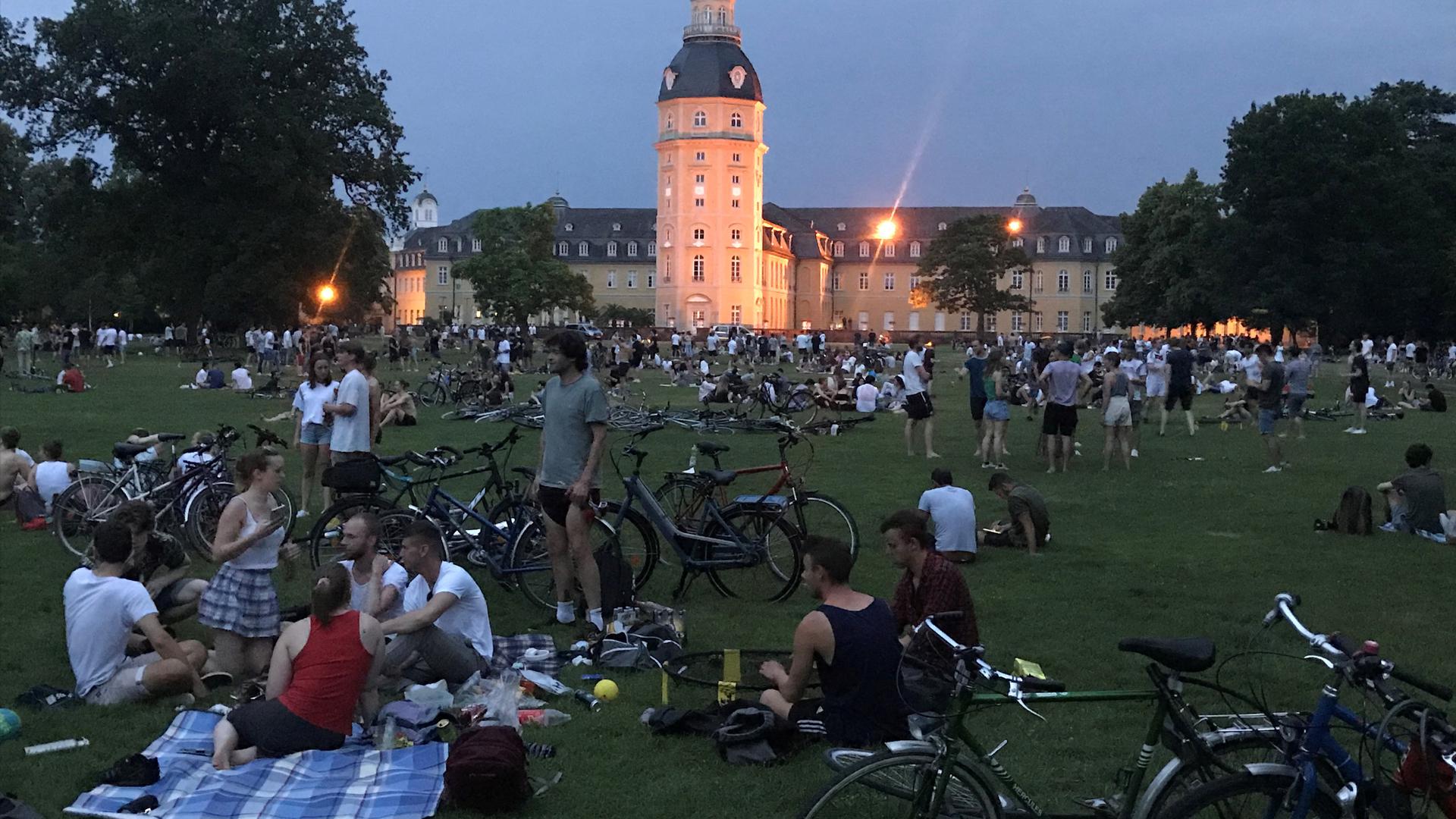 Feierstimmung: Mehrere hundert junge Leute halten sich am Samstag Abend in ausgelassener Stimmung im Schlossgarten auf. Die Polizei wird sie später zum Verlassen des Geländes auffordern.