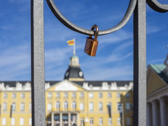 Ein Schloss hängt an einem Gitter vor dem Schloss Karlsruhe.
