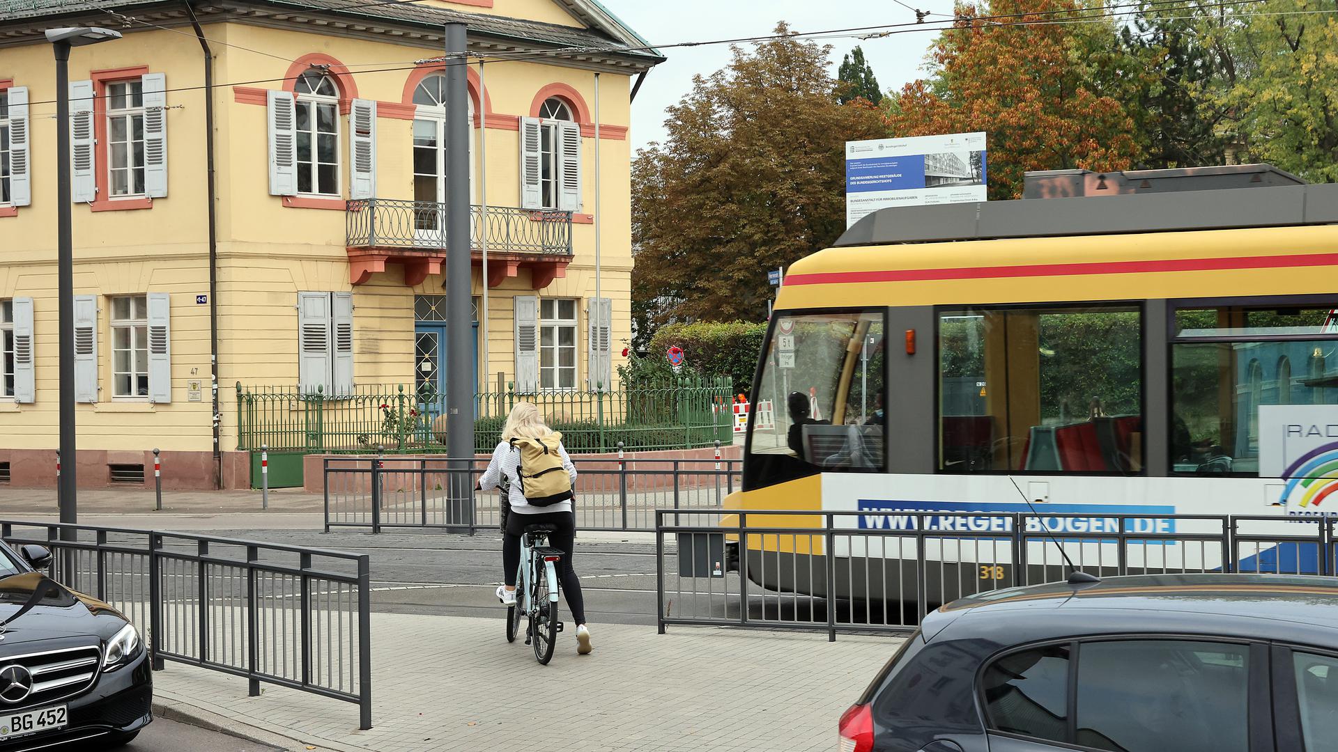Am 14.10.2022 wartet eine Radfahrerin am neu gestalteten Überweg am Karlstor darauf, freie Bahn Richtung Osten zu haben.