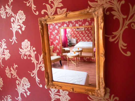 In einem Spiegel spiegelt sich ein Arbeitszimmer des Bordells „Lauras Girls“ in Karlsruhe.