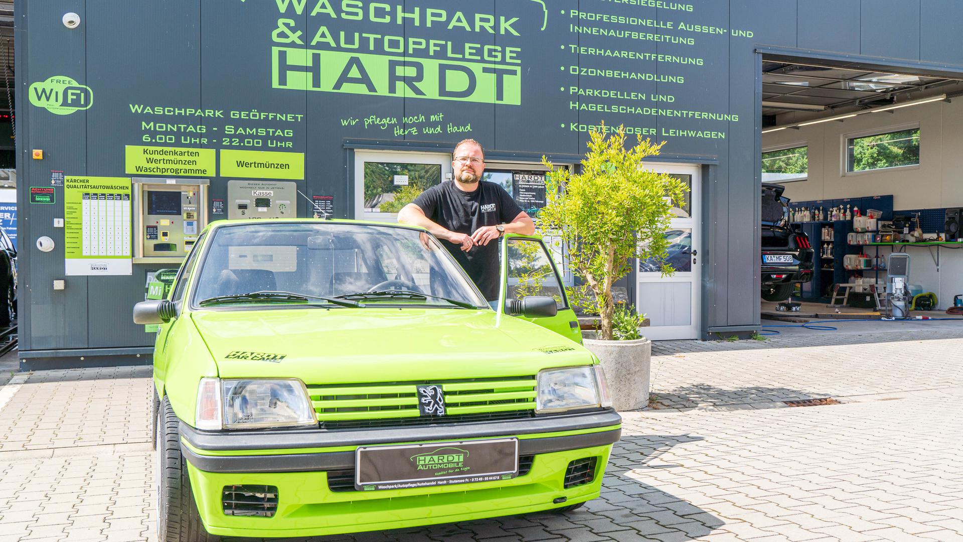 Heiko Hofheinz vor seiner Werkstatt an einem umgebauten Peugeot.