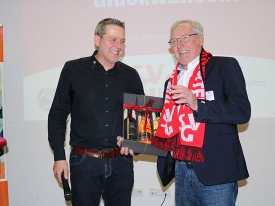 Ralph Oberacker (links) überreicht Dietmar Pfähler einen Fanschal: „Damit Du für die richtige Seite klatschst“. 