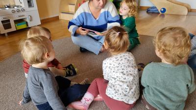 Jana Anderten nimmt die kleinen  Zuhörer mit in die bunte Welt der Kinderbücher. Dabei sind alle mucksmäuschenstill und
hören gespannt zu. 