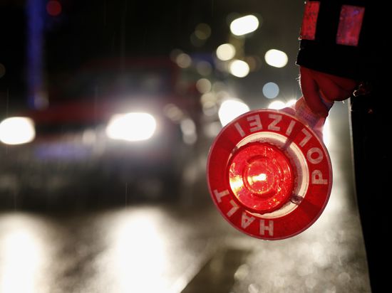 Ein Polizeibeamter hält am 20.02.2015 in Hamburg während einer Verkehrskontrolle eine Kelle in der Hand. Die Hamburger Polizei fährt am Abend und in der Nacht  Kontrollen durch. Da Fahren unter Drogen- und Alkoholeinfluss ist eine der Hauptunfallursachen für folgenschwere Verkehrsunfälle ist, richtet sich die Kontrolle vor allem gegen Rauschmittel im Straßenverkehr. Foto: Jörn Pollex/dpa +++(c) dpa - Bildfunk+++ | Verwendung weltweit