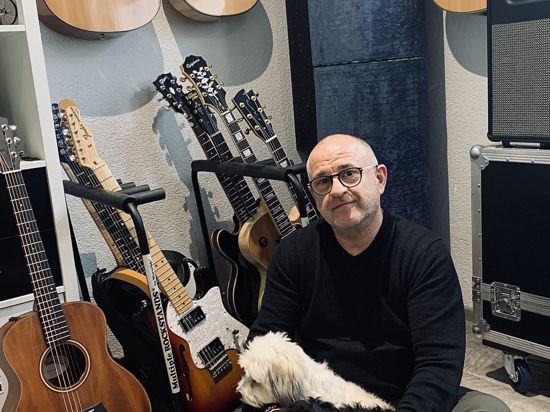 Musiker Freddy Sicko mit seiner Gitarrensammlung und seinen Hunden