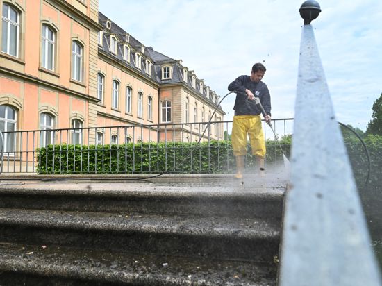 Handwerker reinigt Stufen mit Wasserstrahl
