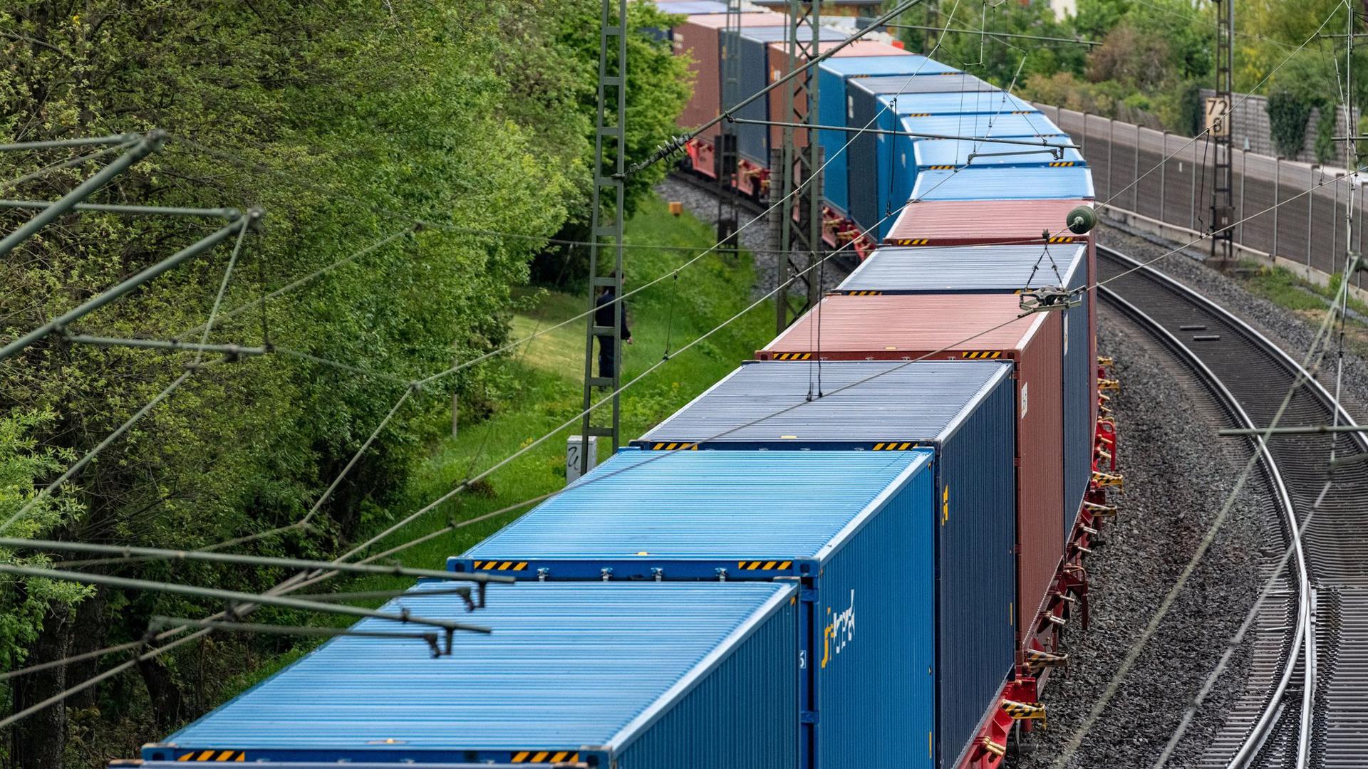 Ein Güterzug fährt auf einer Schiene. 