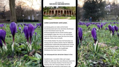 Krokusblüten in Baden-Baden im Hintergrund, im Vordergrund ein Handy-Display mit dem neuen Newsletter über Baden-Baden