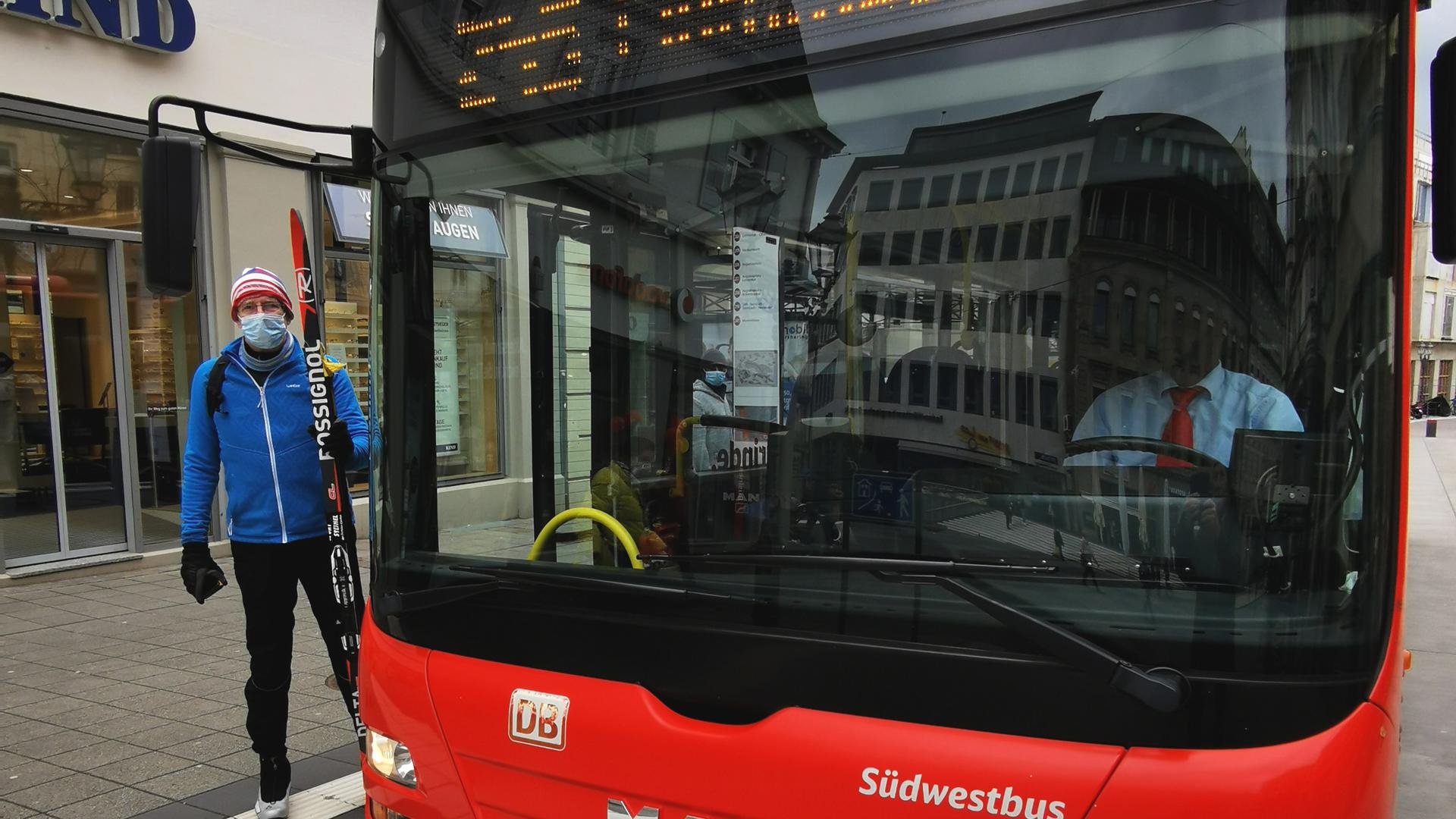 Ein Mann steht in Baden-Baden vor einem Bus, der Richtung Mummelsee fährt.