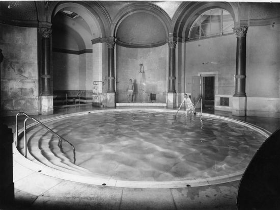 Person geht in ein Schwimmbecken (Schwarz-weiß-Foto)