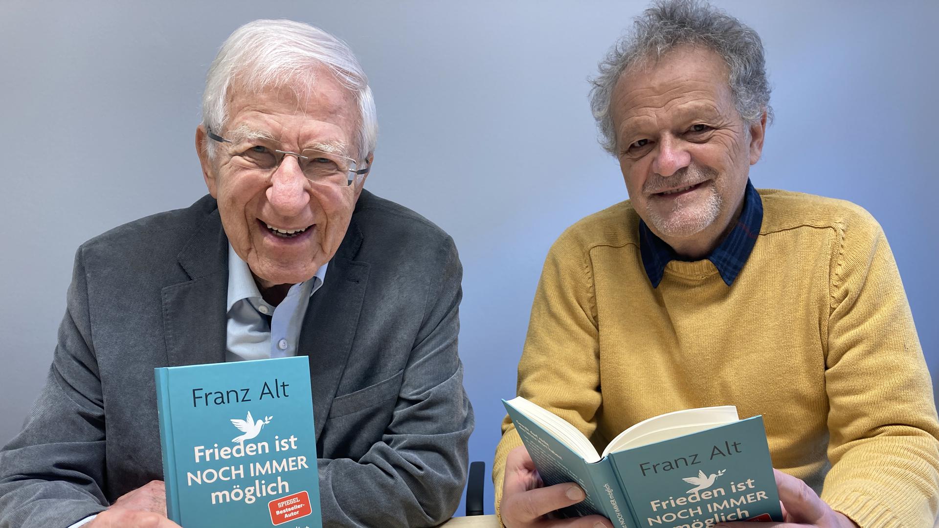 Der Journalist und Buchautor Frank Alt (links) und Werner Henn von der Europa-Union Baden-Baden/Rastatt blättern im Buch „Frieden ist immer noch möglich“ aus der Feder von Alt. 
