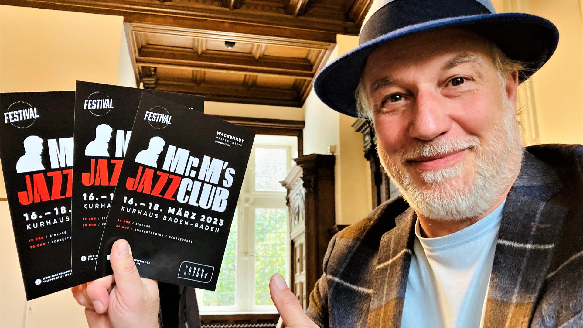 Sänger und Entertainer Marc Marshall hält Flyer für seine Veranstaltung Mr. M’s Jazzclub in den Händen. 