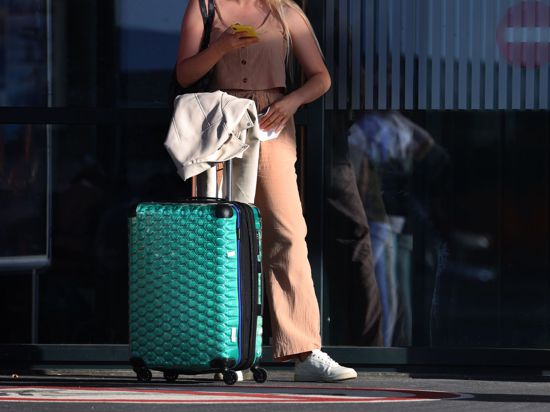 Ein Fluggast steht vor einem Terminal.