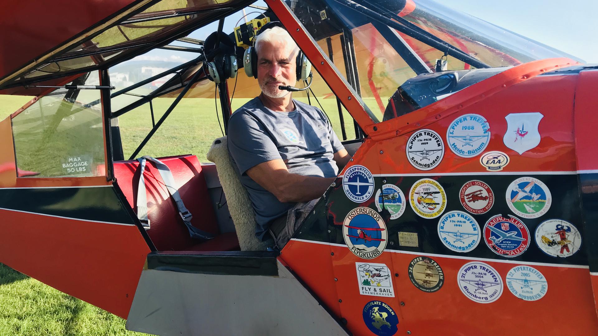 Patrik Ullrich, Vorsitzender des Aeroclub Baden-Baden., sitzt in einem Oldtimer-Motorflugzeug vom Typ D-ELHT (PA 18) des Vereins.