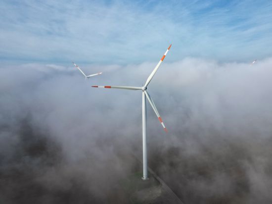 Die Windräder in einem Windpark ragen aus dem Morgennebel hervor. Bis zum Ende des Jahrzehnts wird die Welt der internationalen Energieagentur IEA zufolge hinsichtlich der Energieversorgung deutlich anders aufgestellt sein.(zu dpa "IEA sieht bis 2030 deutliche Änderungen im Energiesektor") +++ dpa-Bildfunk +++