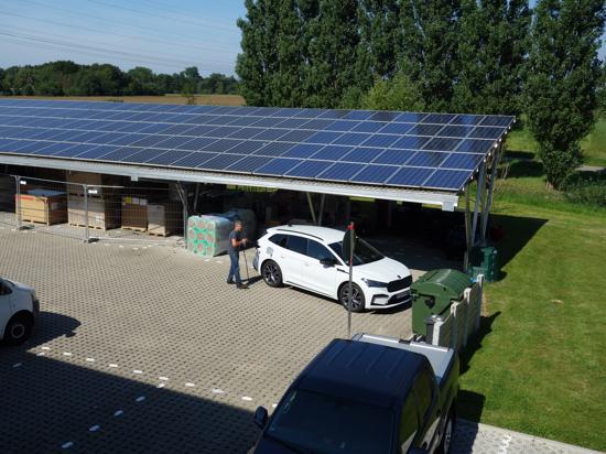 An die Zapfstelle: Ein Mitarbeiter der Firma Veith schließt einen Firmenwagen an die Ladesäule an, die von den Solarzellen auf dem Dach gespeist werden. 