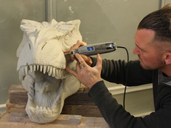 Der Steinbildhauer Florian Weber aus Bühl arbeitet an einem Dino-Kopf.
