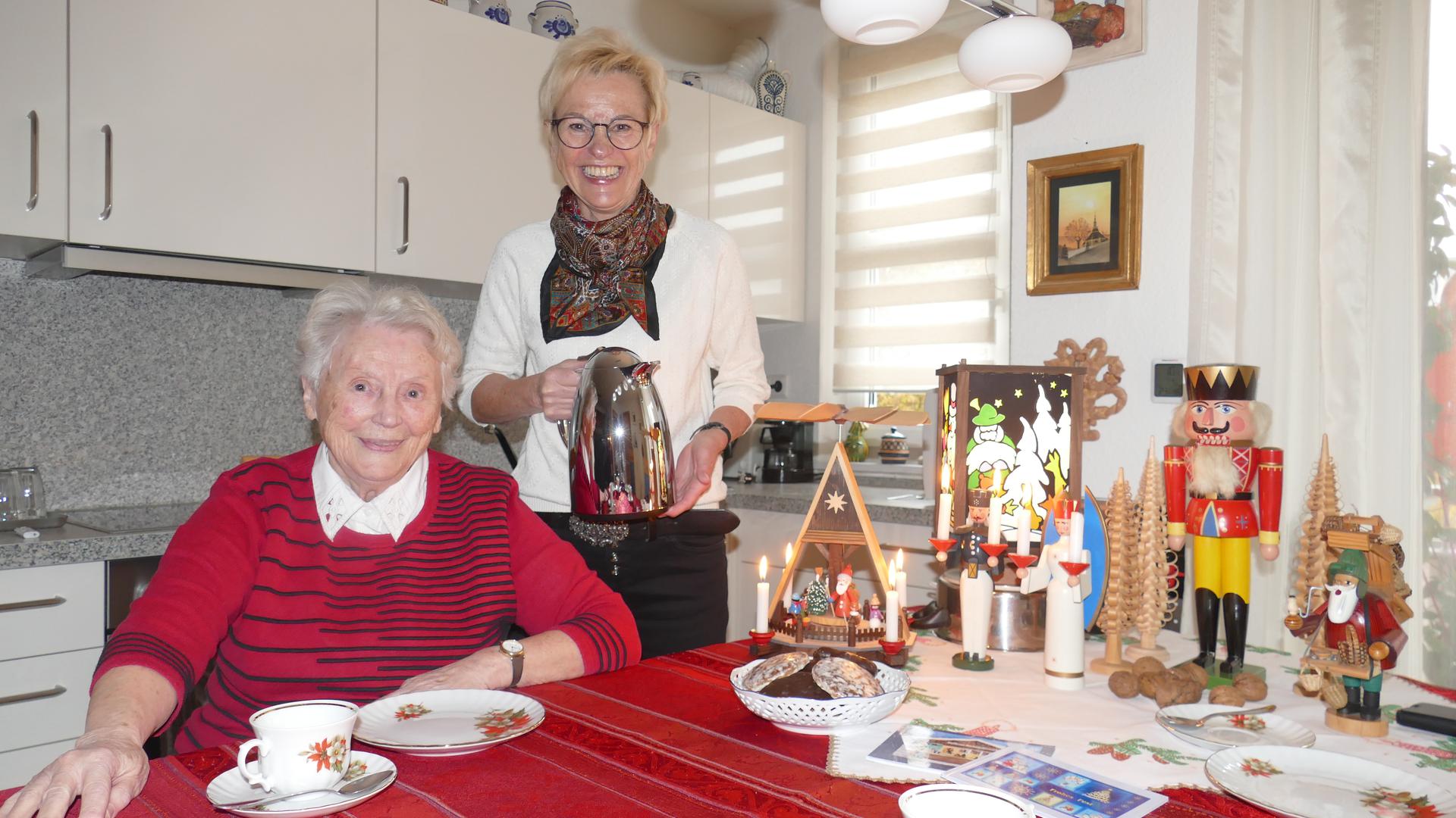 Zwei Frauen in einer Küche mit Weihnachtsfiguren 