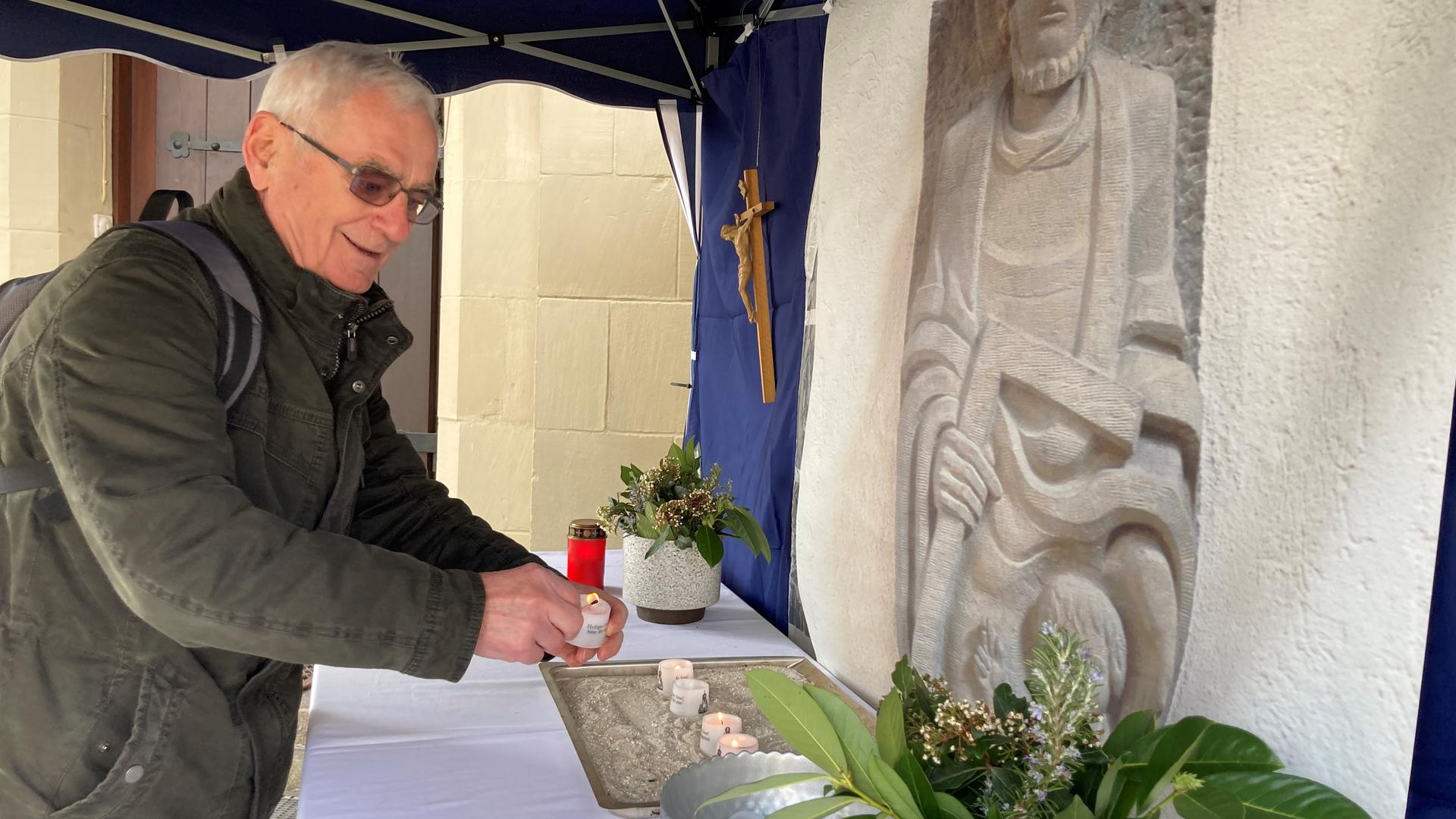 Ivan Labazan zündet ein Teelicht im Gebetszelt von Sankt Josef in Gaggenau an