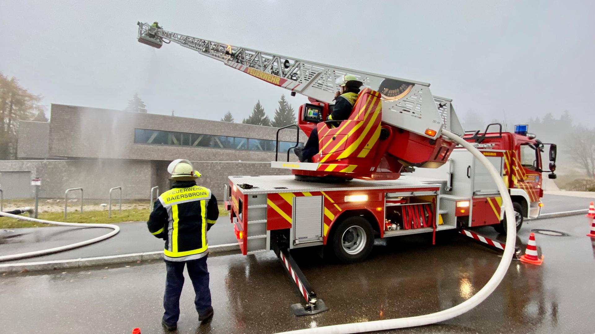 Die Feuerwehr löscht bei einer Übung einen Brand am Nationalparkzentrum Ruhestein mit Hilfe eines Leiterwagens. 