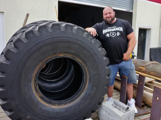 Strongman-Profi Dennis Kohlruss neben einem riesigen Autoreifen.