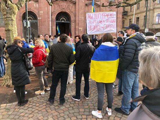 Deutsche und ukrainische Familien stehen während einer Kundgebung auf dem Marktplatz in Rastatt.