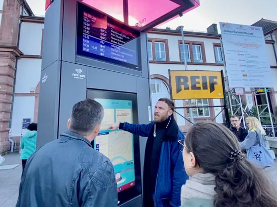 Zentrales Element: Der KVV-Projektleiter Frank Pagel zeigt das Informationsterminal der Regiomove-Ports vor dem Rastatter Bahnhof. Auf dem Bildschirm darüber werden die nächsten Abfahrtszeiten gezeigt. 