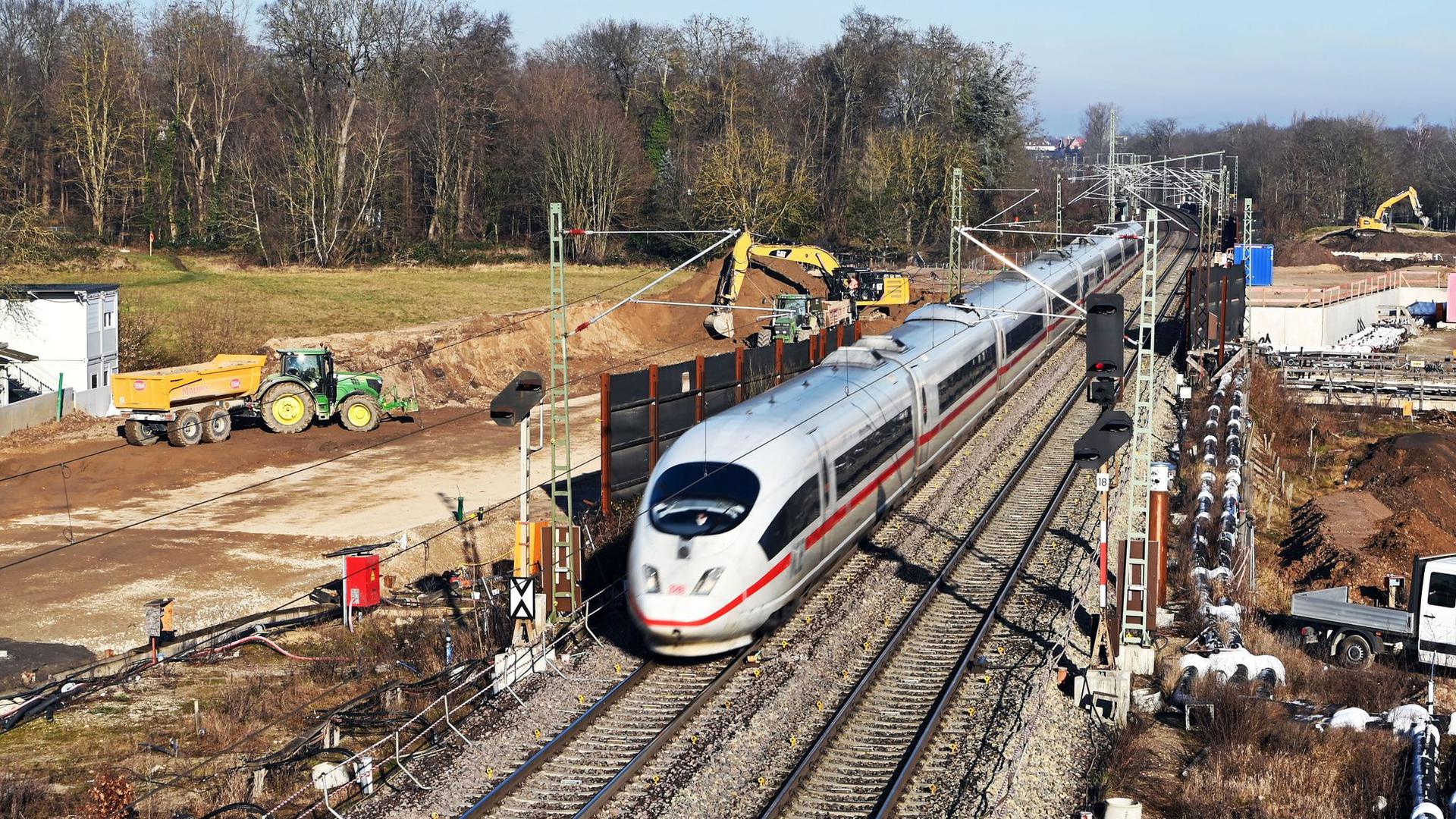 Im Bereich der Bahntunnelbaustelle bei Niederbühl fährt ein Zug über die Rheintalbahn.