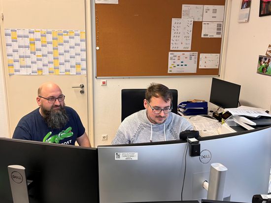 Zwei IT-Mitarbeiter der Stadt Rastatt sitzen nach dem Hackerangriff vor einem Computer im Rathaus.