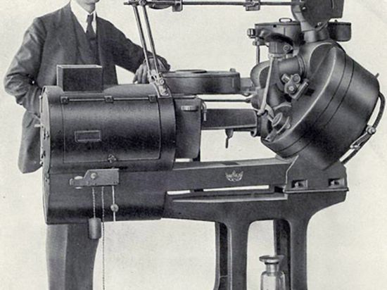Der Erfinder und sein Werk: Emil Mechau mit seinem Filmprojektor, der nach dem System des optischen Ausgleichs erstmals ruckel- und flimmerfreie Filmvorführungen ermöglichte.