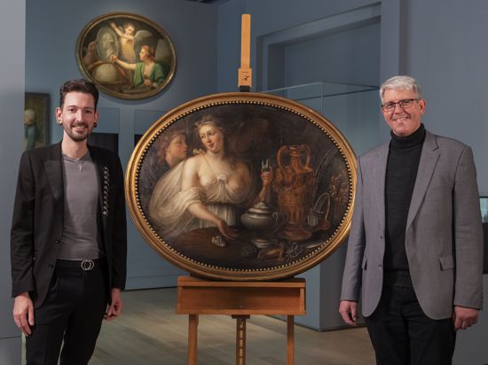 Fabian Kahl, Kunsthändler aus der ZDF-Sendereihe „Bares für Rares“ (links), und Olaf Siart, Kurator im Landesmuseum Württemberg, stehen neben dem Gemälde, das das Museum von Kahl erworben hat