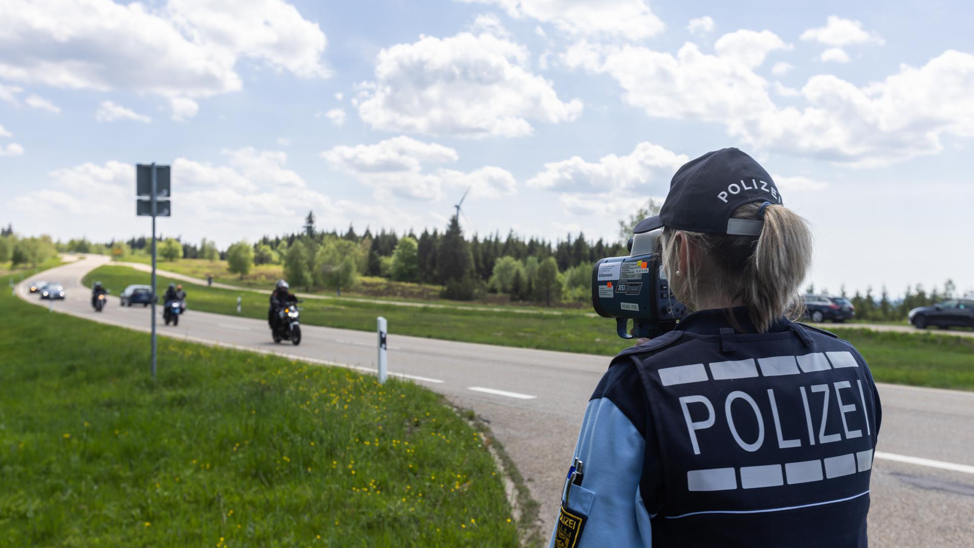 Eine Polizeibeamtin misst die Geschwindigkeit von Motorradfahrern im Landkreis Freudenstadt.