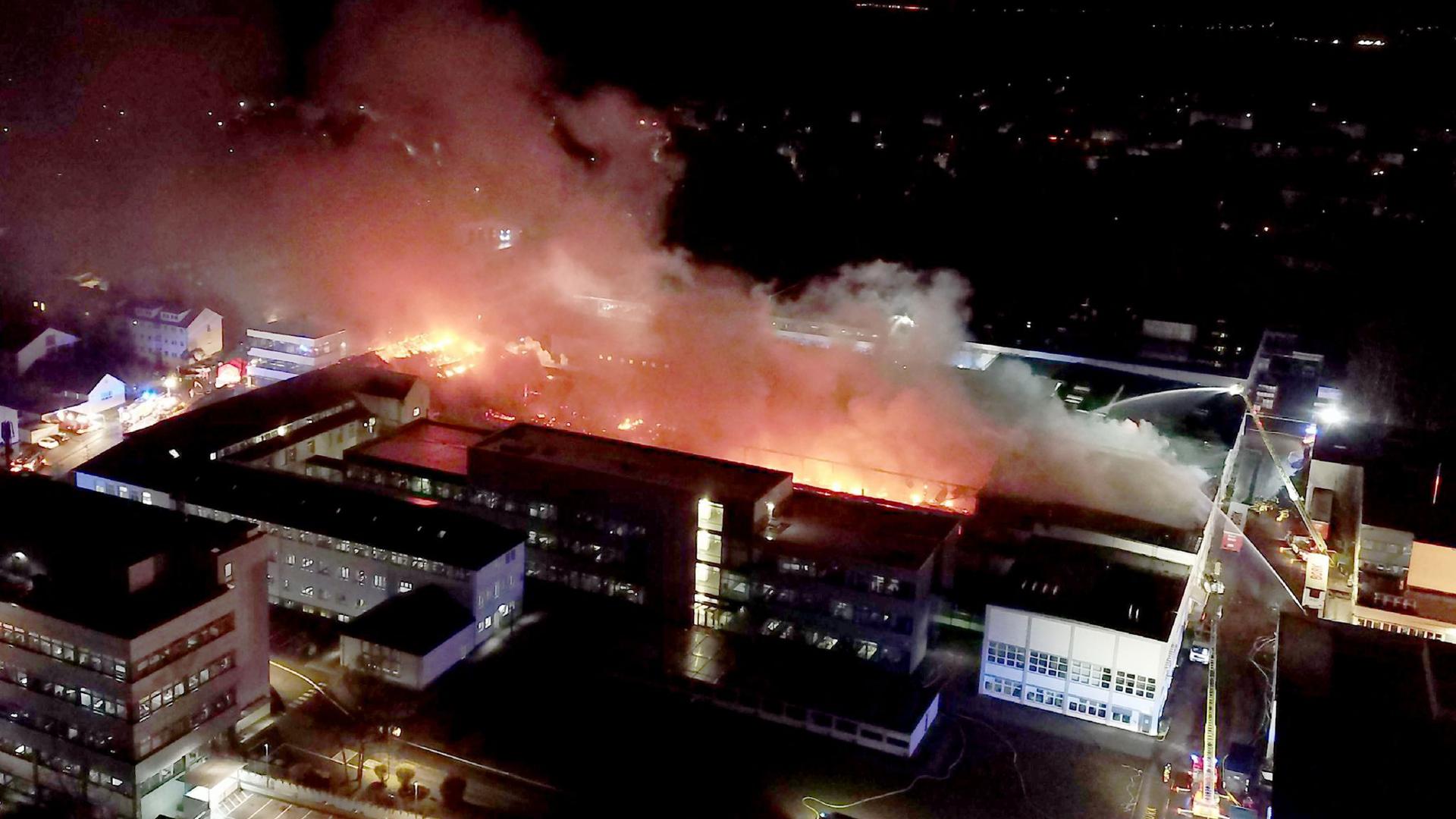 Einsatzkräfte der Feuerwehr löschen den Großbrand auf dem Gelände von Bosch Thermotechnik in Wernau.