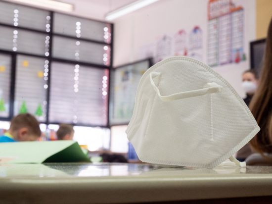 Eine FFP2-Maske liegt in einer Grundschule auf einem Tisch.