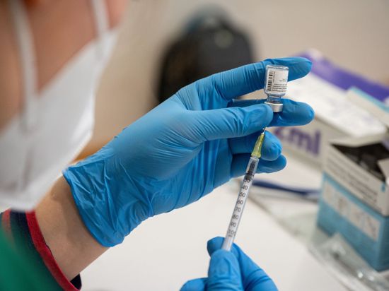 Die Mitarbeiterin eines mobilen Impfteams bereitet eine Spritze mit einem Impfstoff gegen das Coronavirus vor.
