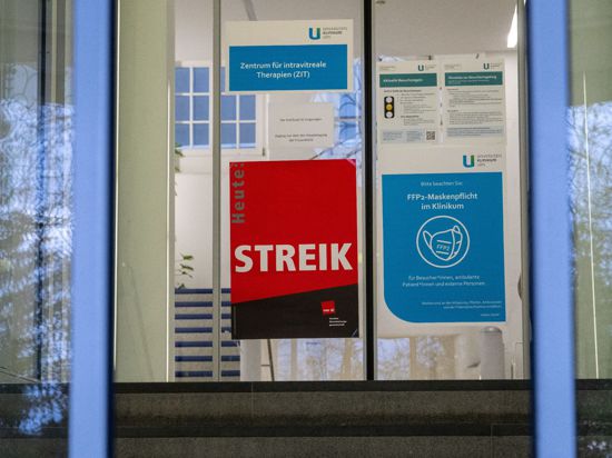 An einer Eingangstür zur Uniklinik weist ein Plakat auf einen Streik hin.