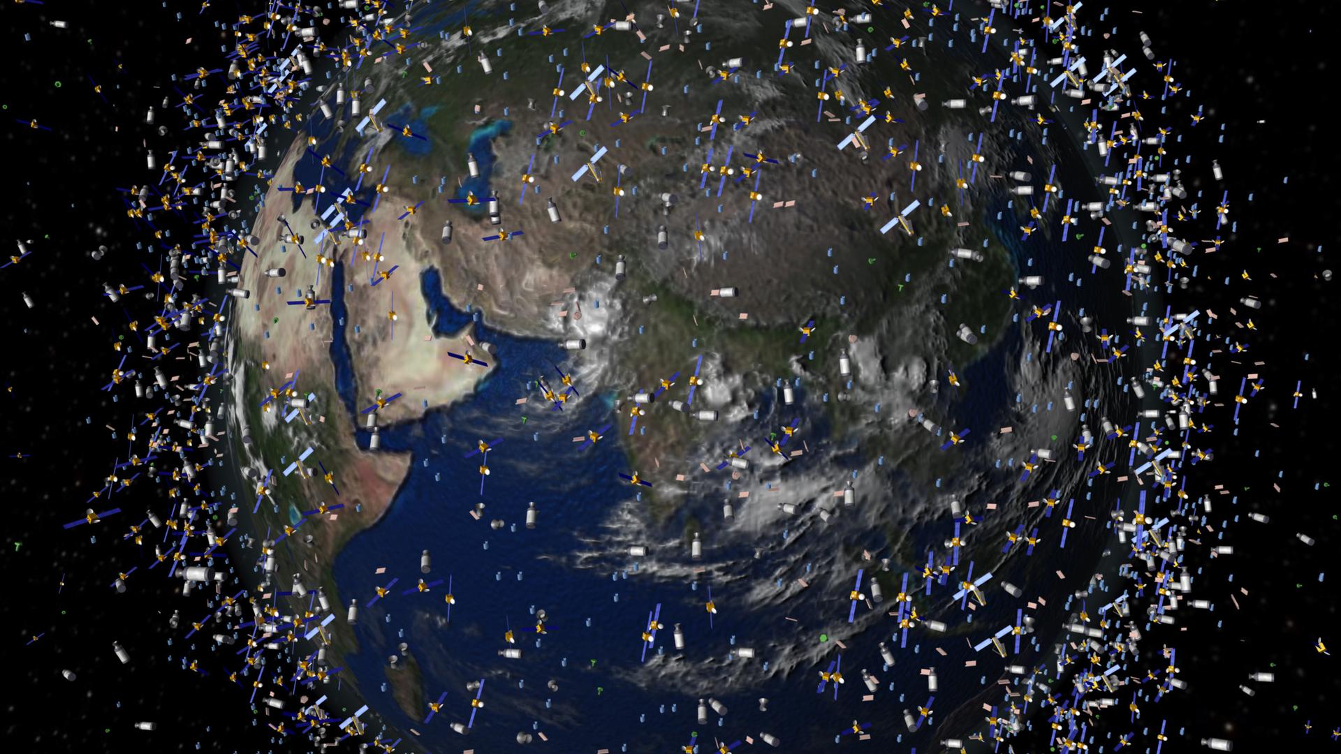 Die Bedrohung durch Kollisionen steigt täglich: Das computergenerierte Bild der European Space Agency (ESA) zeigt den Weltraummüll früherer Weltraummissionen, der neben intakten Satelliten um die Erde kreist.