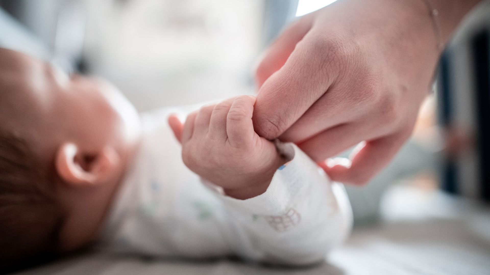 Ein Baby klammert sich an den Finger seiner Mutter. Frauen in Deutschland haben im Jahr 2019 weniger Babys auf die Welt gebracht als 2018.