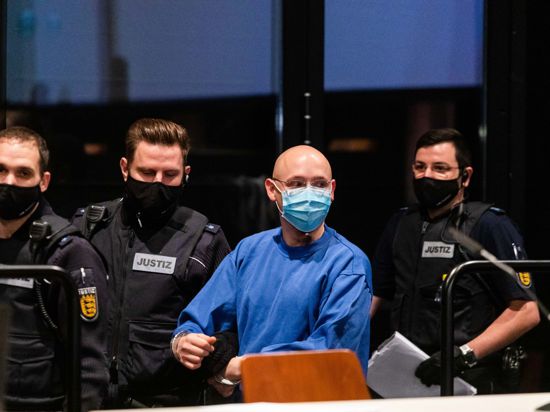 Der Angeklagte Yves R. wird von Justizbeamten in den Verhandlungssaal im Landgericht Offenburg geführt.
