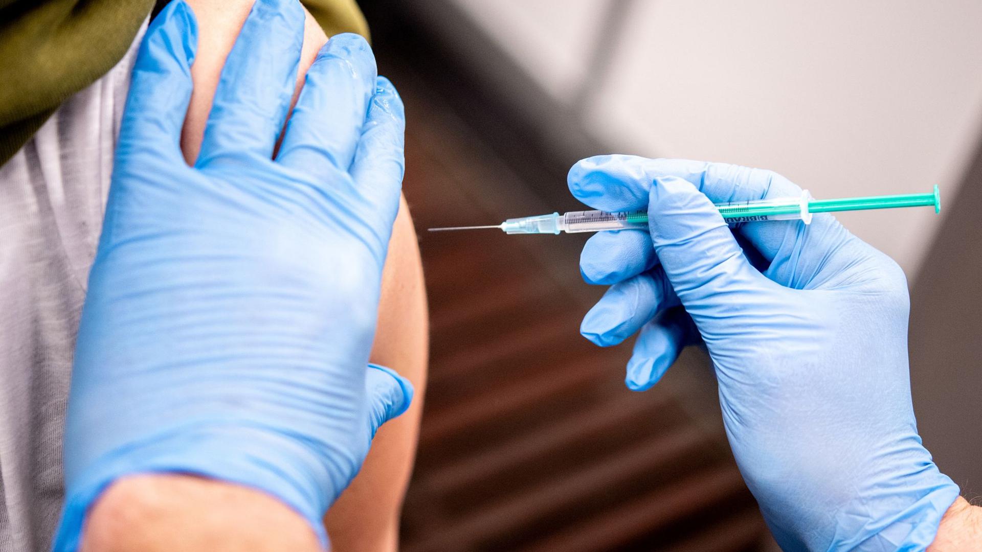 Eine Erzieherin erhält im Bremer Impfzentrum den Impfstoff von AstraZeneca.