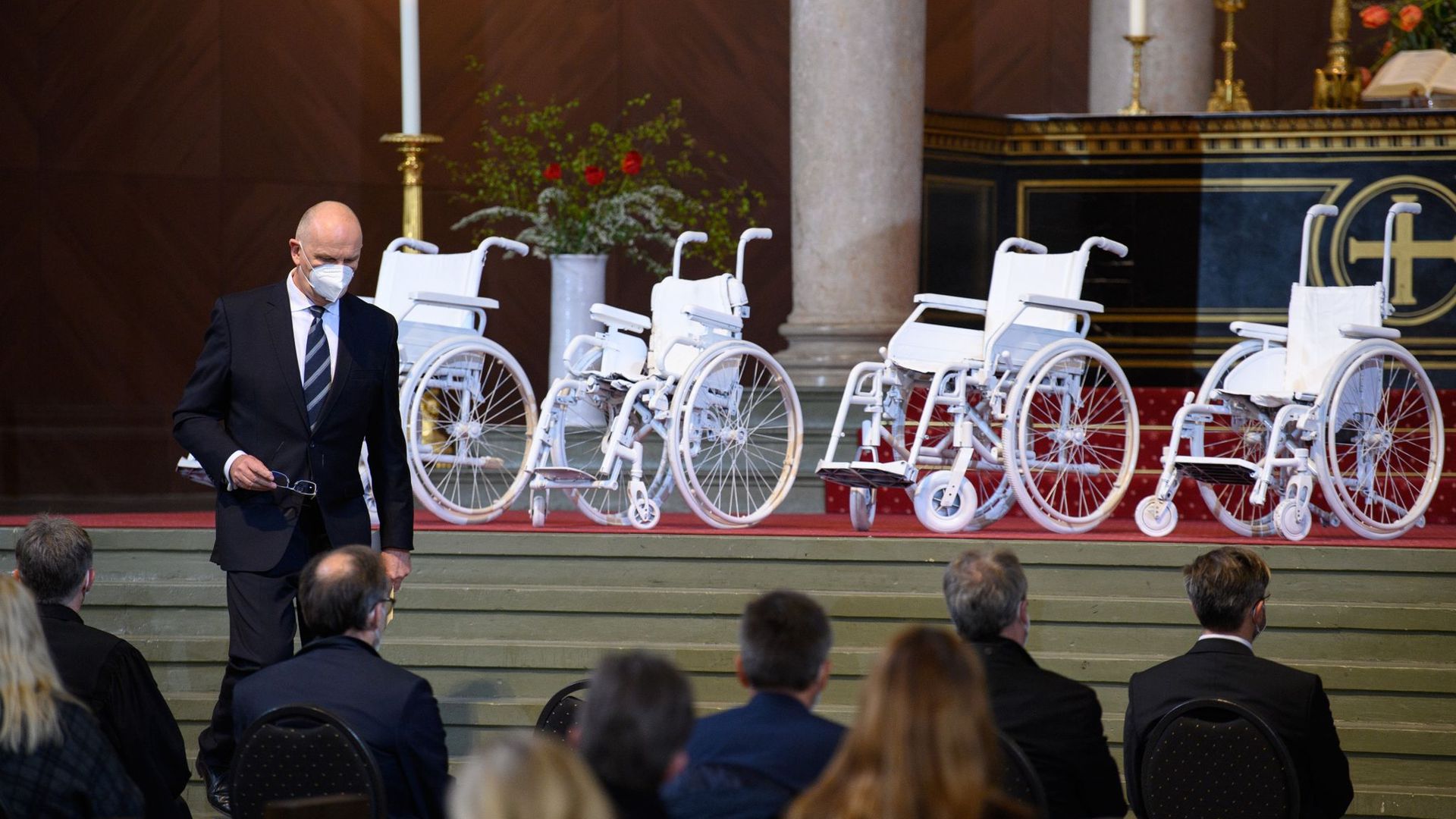 Dietmar Woidke (SPD), Ministerpräsident von Brandenburg, geht während eines Gedenkgottesdienstes in der Nikolaikirche für die getöteten Bewohner des Oberlinhauses nach seiner Rede an den vier weißen Rollstühlen im Altarraum vorbei zu seinem Platz.