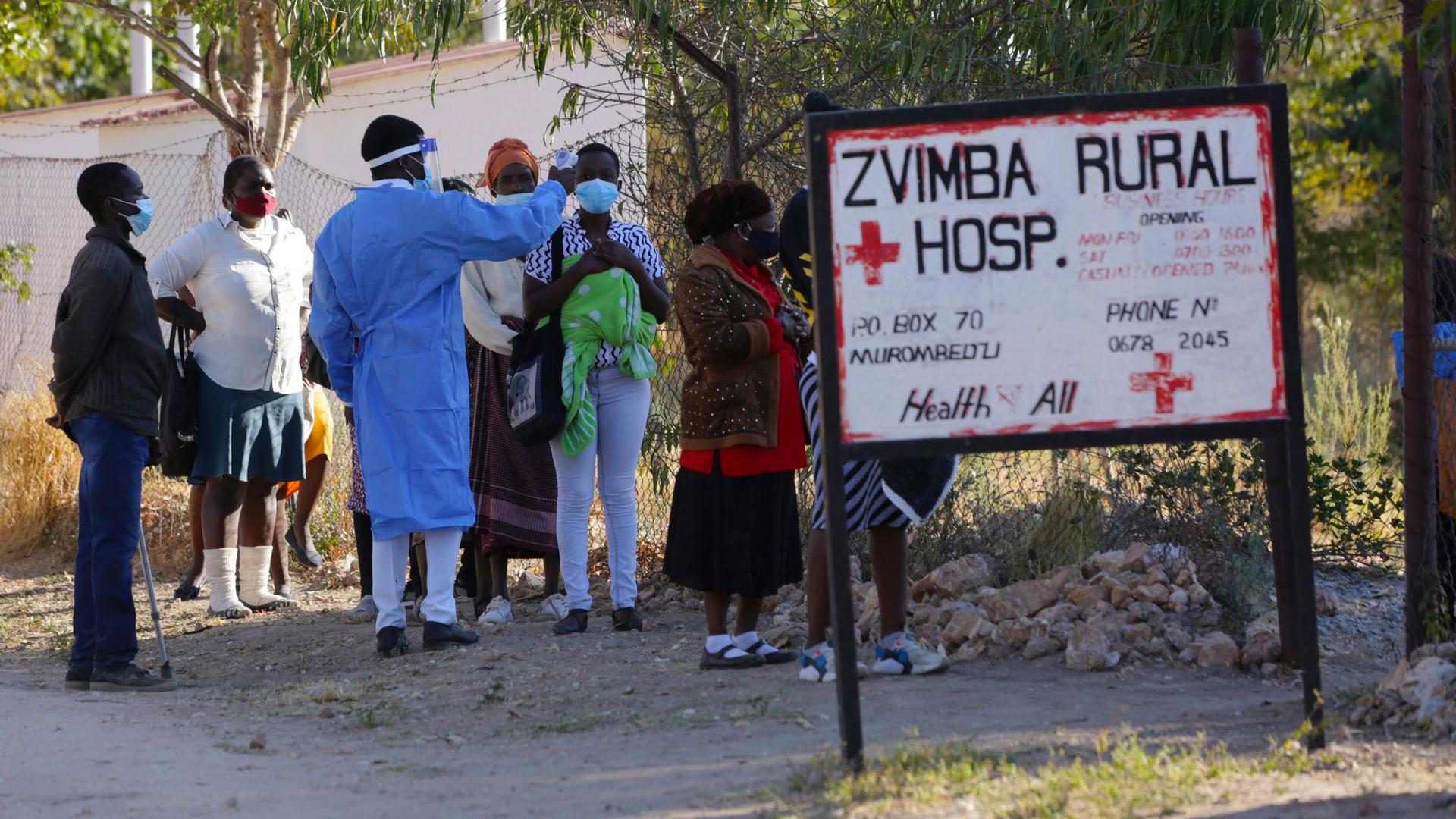 Bewohnern wird in Zvimba, Simbabwe, die Temperatur gemessen, bevor sie sich im örtlichen Krankenhaus behandeln lassen können.