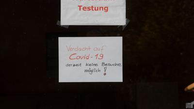 "Warteraum Testung“ und „Verdacht auf Covid-19 derzeit keine Besuche möglich!“ steht auf Zetteln an einer Scheibe in dem Seniorenheim, in dem es zum Corona-Ausbruch gekommen ist.