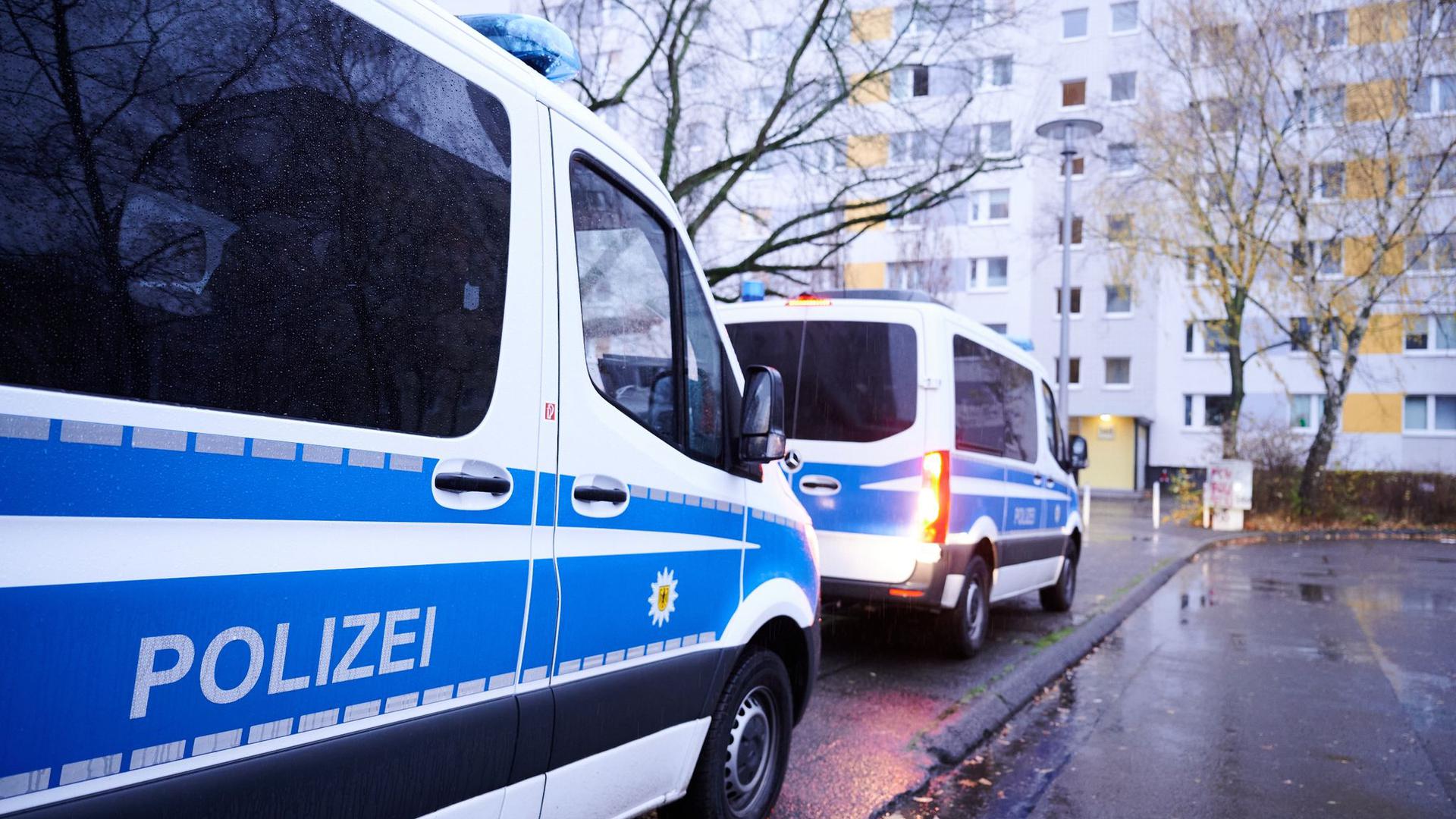 Fahrzeuge der Bundespolizei vor einem Wohnhaus in Berlin. Die Durchsuchung steht im Zusammenhang mit dem Verdacht auf Schleuserkriminalität.