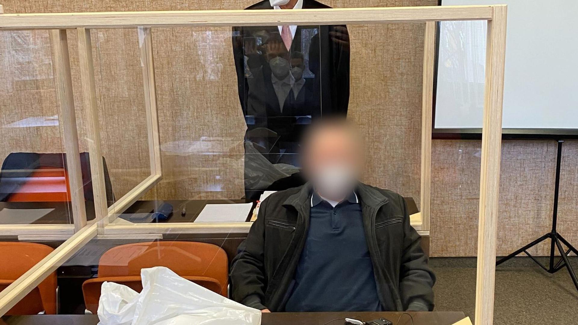Der angeklagte Vater (vorne) zusammen mit seinem Anwalt (hinten) vor dem Prozess am Landgericht München I.