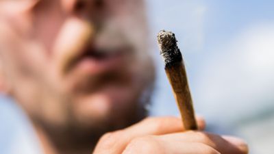 Ein Mann raucht während einer Demonstrationen für eine zügige Legalisierung von Cannabis einen Joint mit Medizinalcannabis.