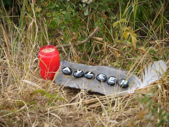Eine Kerze und eine Tafel mit dem Namen Ayleen am Ufer des Teufelsees, wo die Leiche der 14-Jährigen gefunden wurde.