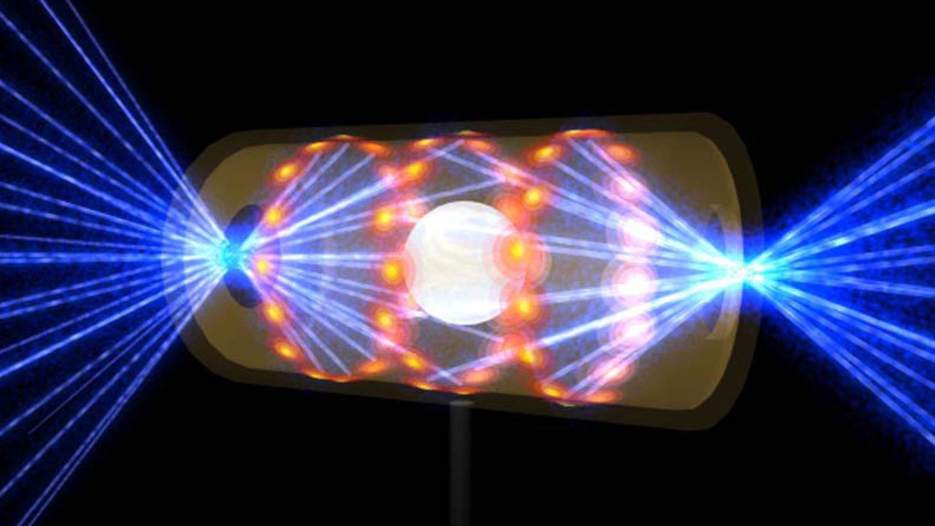 Diese Illustration zeigt ein NIF-Target-Pellet in einer Hohlraumkapsel mit Laserstrahlen, die durch Öffnungen an beiden Enden eintreten. Die Strahlen komprimieren und erhitzen das Target auf die Bedingungen, die für die Kernfusion erforderlich sind.