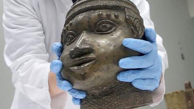 Eine Museumsmitarbeiterin verpackt eine der Benin-Bronzen, die für die Rückgabe nach Nigeria im Ethnologischen Museum Dahlem zusammen gestellt wurden.