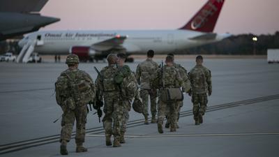 Soldiers of the 82nd Airborne Division walk on the tarmac as they deploy to Europe, February 14, 2021, in Fort Bragg, North Carolina. - US service members based in Fort Bragg, North Carolina, are preparing deploy to Europe as the crisis between Russia and Ukraine escalates. (Photo by Allison Joyce / AFP)